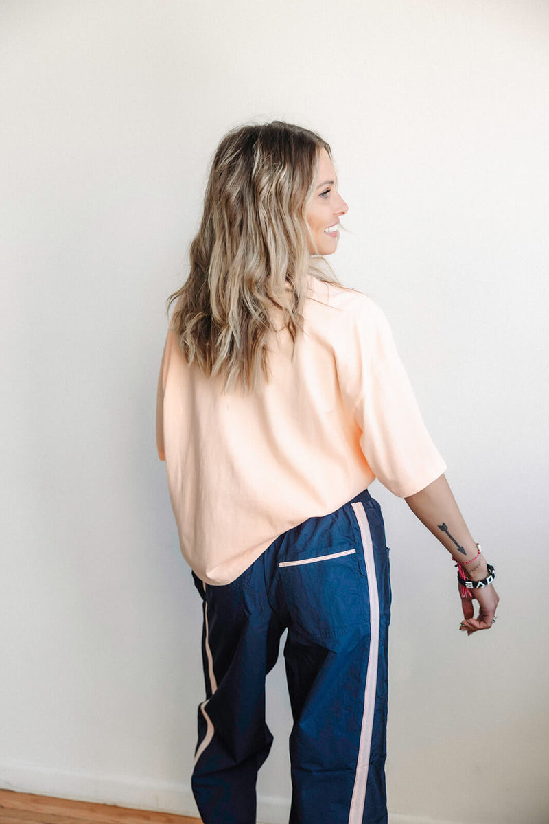 arlo-free-people-movement-logo-tackle-tee-pastel-peach